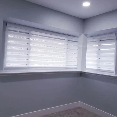 Zebra Light Filtering Roller Shades in a Bedroom